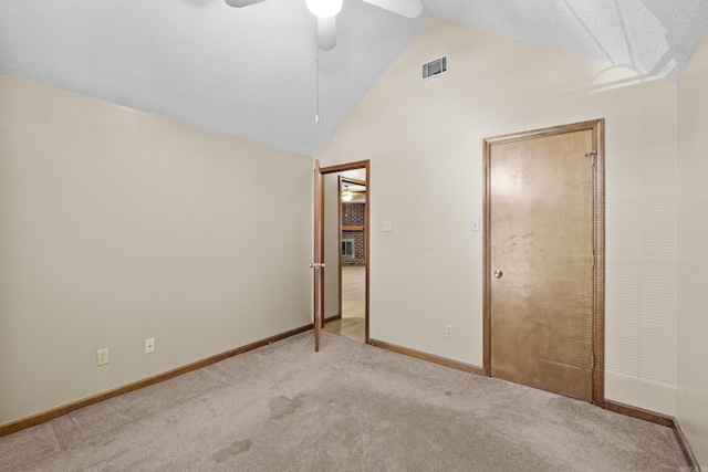 unfurnished bedroom featuring carpet, visible vents, ceiling fan, high vaulted ceiling, and baseboards