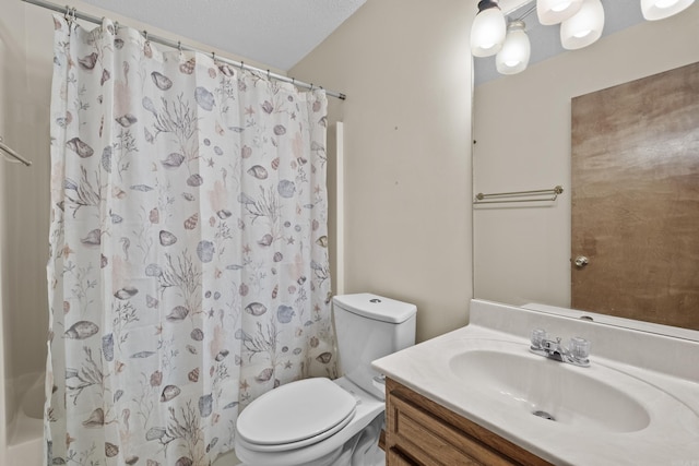 bathroom featuring curtained shower, vanity, and toilet