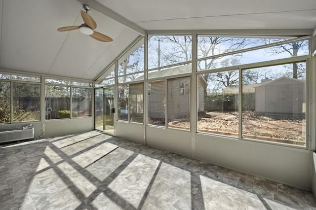 unfurnished sunroom with lofted ceiling with beams, a wealth of natural light, and a ceiling fan