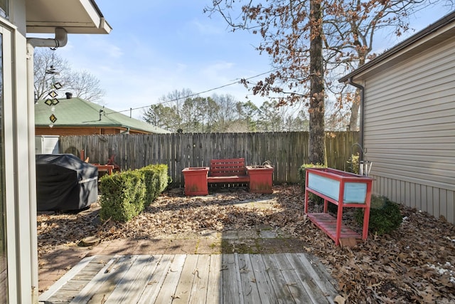 wooden terrace with fence and a grill