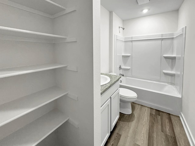 full bath featuring shower / washtub combination, vanity, toilet, and wood finished floors