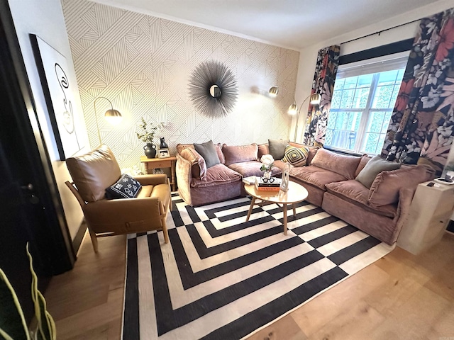 living room with an accent wall, wood finished floors, and wallpapered walls