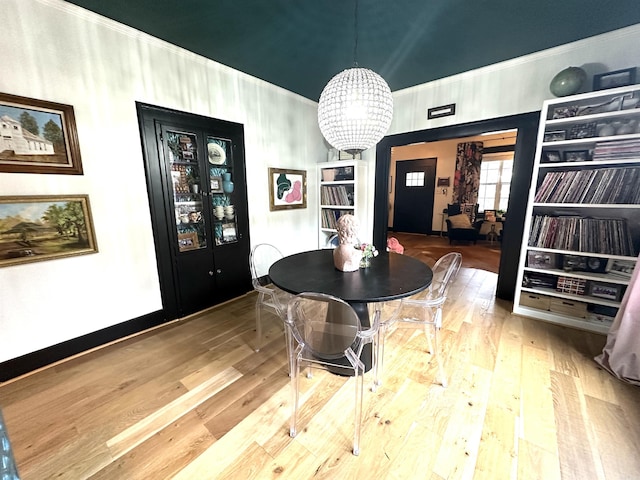 dining area with a chandelier and wood finished floors