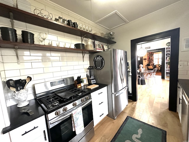 kitchen featuring open shelves, dark countertops, light wood-style flooring, backsplash, and appliances with stainless steel finishes