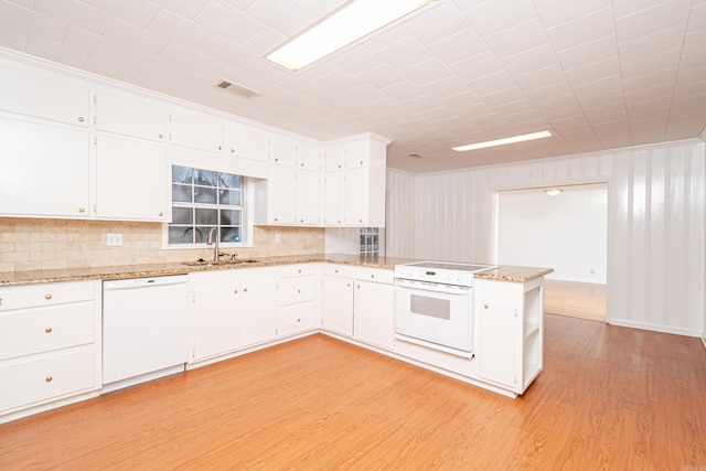 kitchen with visible vents, light wood-style flooring, white cabinets, white appliances, and a peninsula