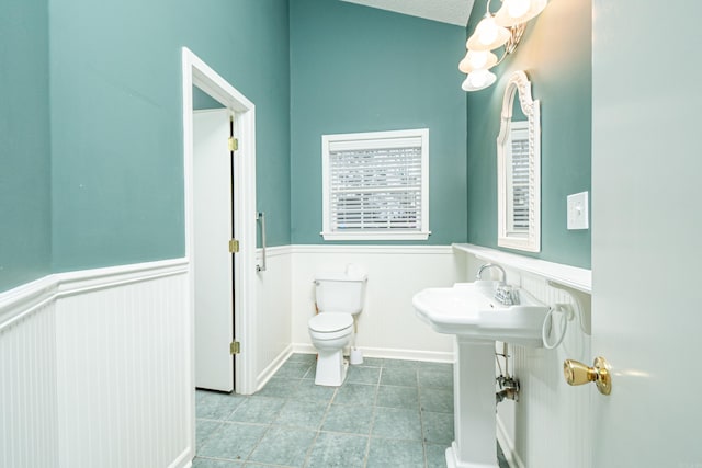 875 Ouachita 64, Camden, AR 71701 - bathroom featuring tile patterned flooring, a wainscoted wall, and toilet