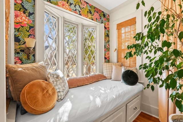 sitting room with a healthy amount of sunlight, baseboards, and wood finished floors