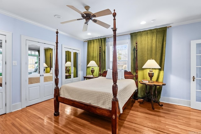 bedroom with french doors, baseboards, crown molding, and light wood finished floors