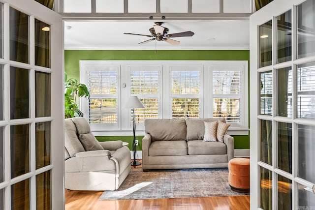 sunroom with plenty of natural light and a ceiling fan