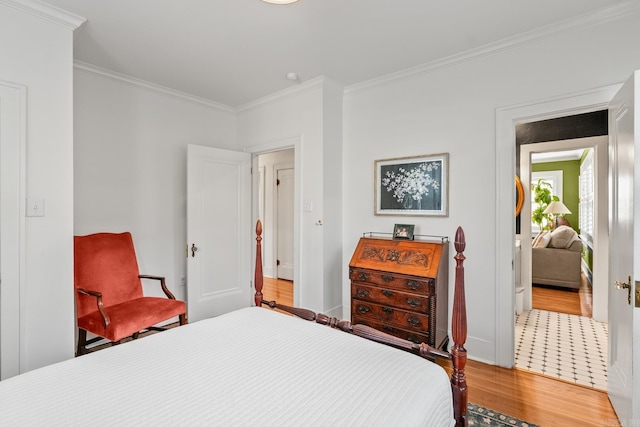 bedroom with crown molding, baseboards, and wood finished floors