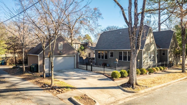 view of front of home with a garage, brick siding, an outbuilding, and fence