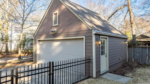 detached garage featuring a gate and fence