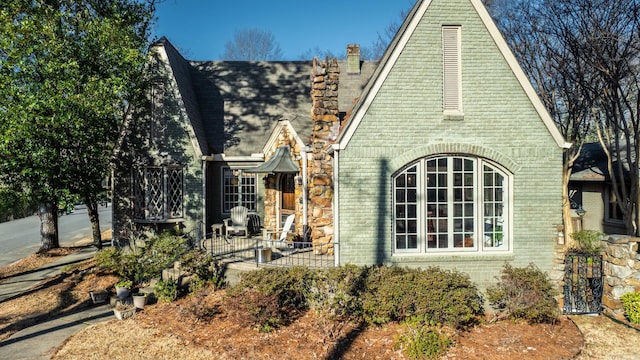 exterior space with brick siding and a chimney