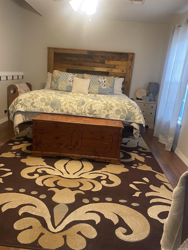 bedroom with visible vents and wood finished floors