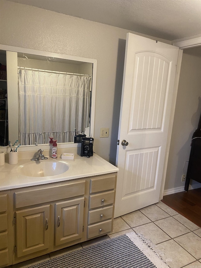 bathroom featuring tile patterned flooring and vanity