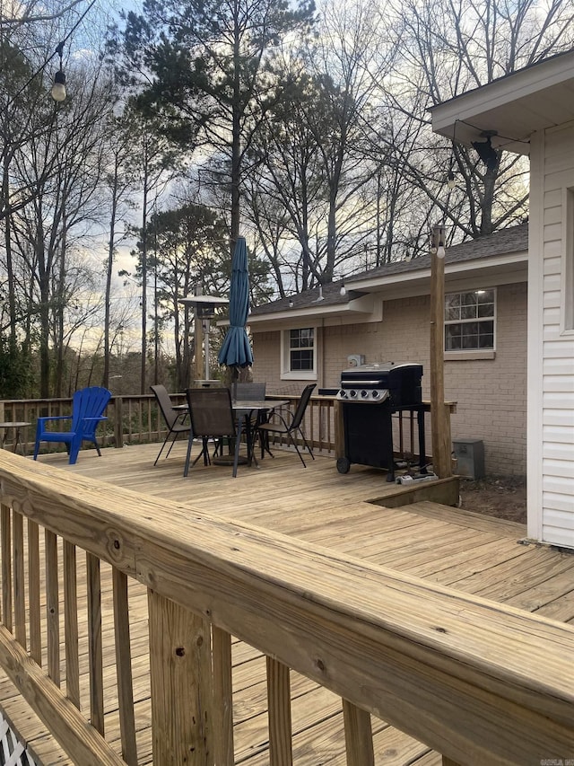 wooden deck featuring grilling area and outdoor dining space