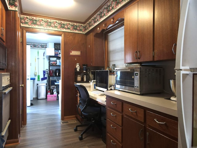 office featuring wallpapered walls and dark wood-type flooring