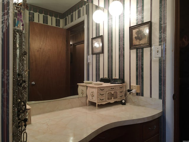 bathroom with wallpapered walls