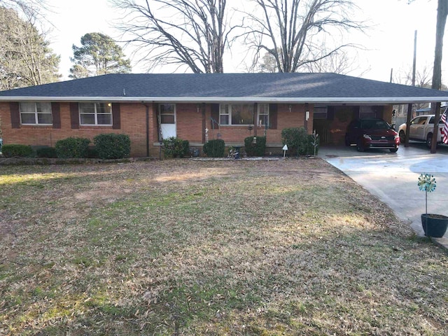 ranch-style house with an attached carport, brick siding, concrete driveway, and a shingled roof