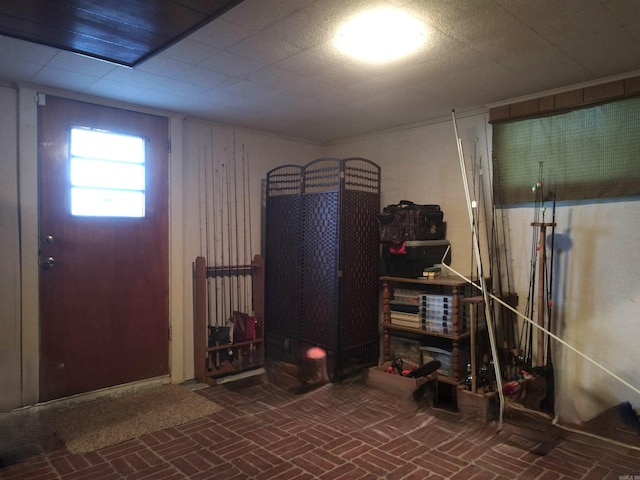 basement featuring brick floor