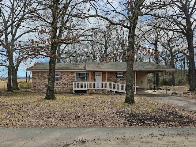 single story home with a carport, brick siding, crawl space, and driveway