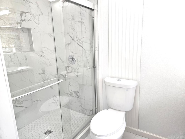 full bath with marble finish floor, baseboards, toilet, and a marble finish shower