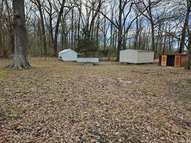 view of yard with a storage unit and an outbuilding