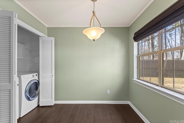 clothes washing area with laundry area, baseboards, a wealth of natural light, and washer / dryer