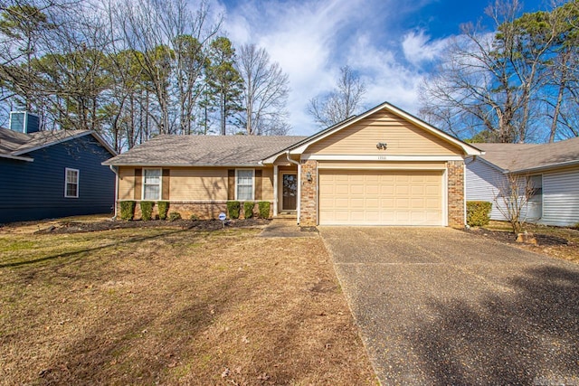 single story home featuring driveway, brick siding, a front lawn, and an attached garage