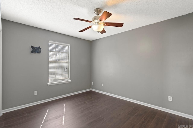 unfurnished room with a ceiling fan, a textured ceiling, baseboards, and dark wood-type flooring