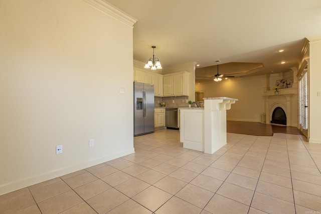 kitchen with light tile patterned floors, stainless steel appliances, crown molding, and open floor plan