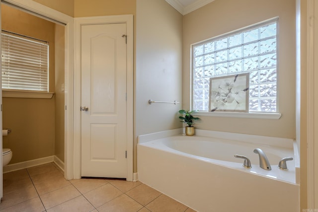 bathroom with ornamental molding, a garden tub, toilet, and tile patterned floors