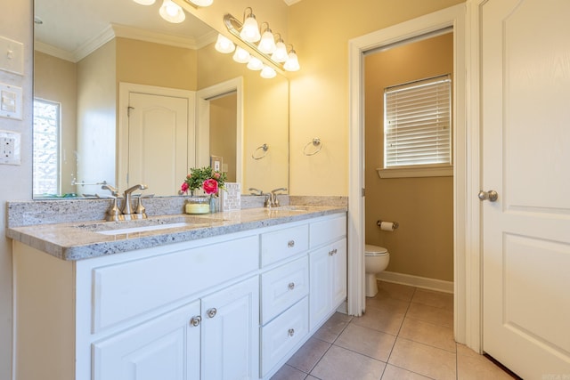 bathroom with crown molding, double vanity, toilet, a sink, and tile patterned flooring