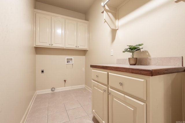 washroom featuring light tile patterned floors, hookup for a washing machine, cabinet space, hookup for an electric dryer, and gas dryer hookup