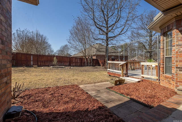 view of yard featuring a fenced backyard and a deck