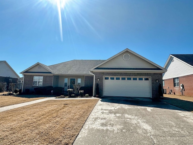 ranch-style house featuring a garage, concrete driveway, brick siding, and a front lawn