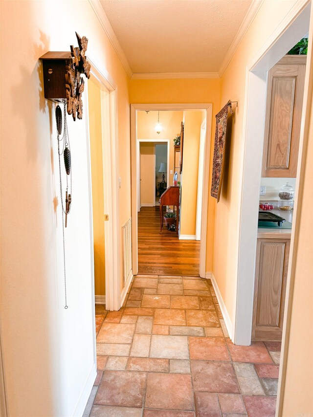 2407 Brittany, Searcy, AR 72143 - hall featuring baseboards, ornamental molding, and stone tile floors