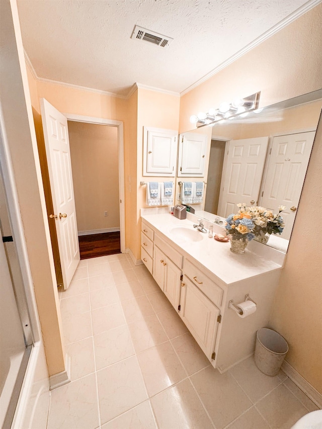 2407 Brittany, Searcy, AR 72143 - bathroom with crown molding, visible vents, a textured ceiling, vanity, and tile patterned floors
