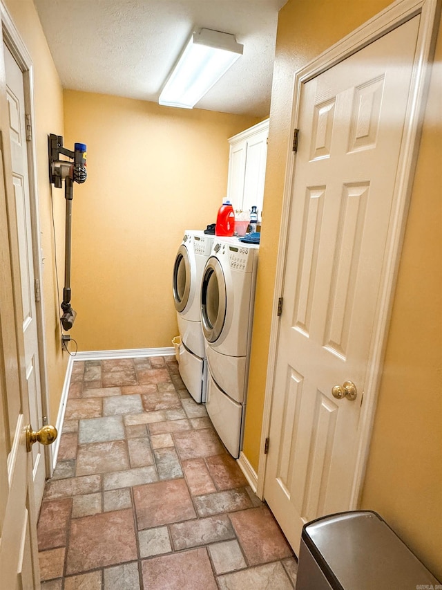 2407 Brittany, Searcy, AR 72143 - laundry room with cabinet space, stone finish flooring, baseboards, and separate washer and dryer
