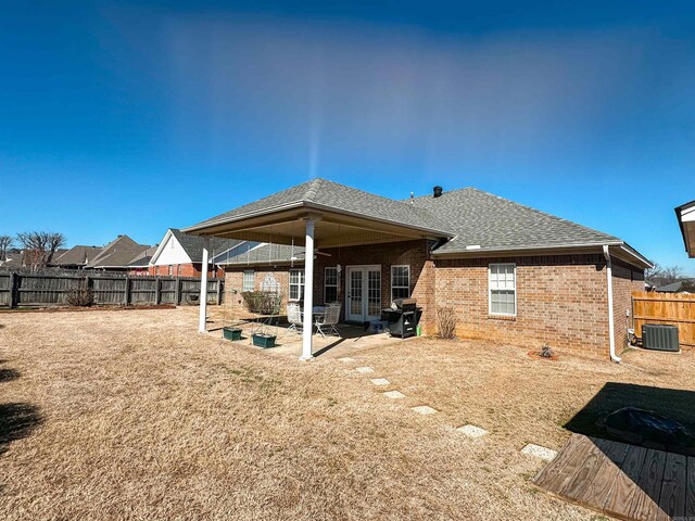 2407 Brittany, Searcy, AR 72143 - back of property featuring a patio, a shingled roof, brick siding, fence, and french doors