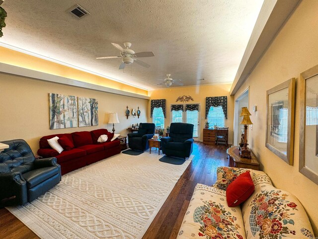 2407 Brittany, Searcy, AR 72143 - living room with a textured ceiling, wood finished floors, visible vents, and a ceiling fan