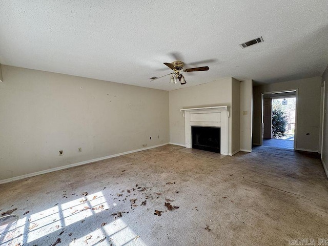 unfurnished living room featuring visible vents, a fireplace with flush hearth, ceiling fan, a textured ceiling, and baseboards