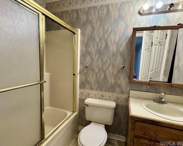 bathroom with vanity, toilet, and wallpapered walls