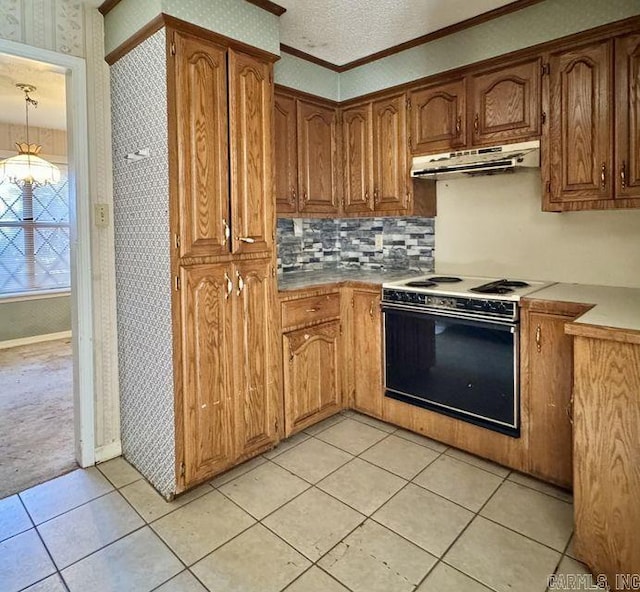 kitchen featuring white range with electric stovetop, brown cabinets, a textured ceiling, under cabinet range hood, and wallpapered walls