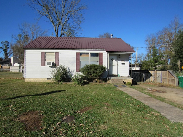 view of front of home with crawl space, fence, metal roof, and a front yard