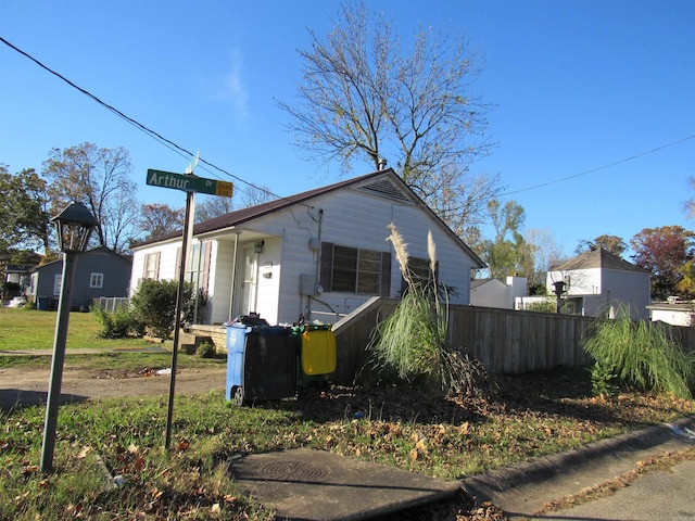 view of side of home featuring fence