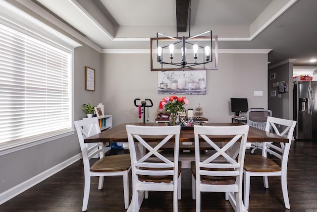 dining room featuring a chandelier, crown molding, dark wood-style flooring, and baseboards