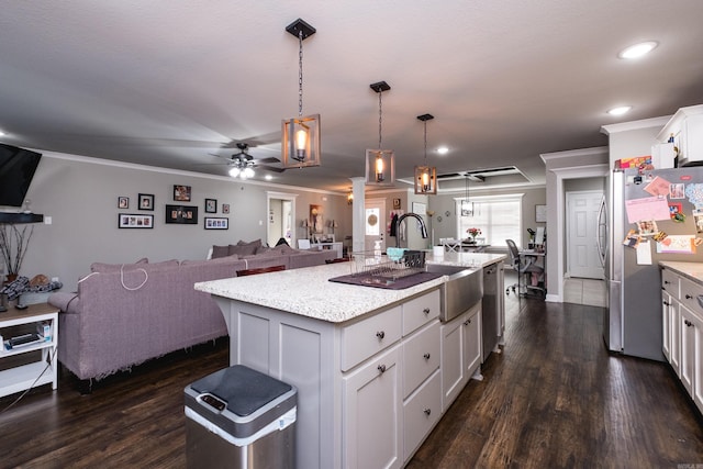 kitchen with white cabinets, dark wood-style floors, stainless steel appliances, and open floor plan