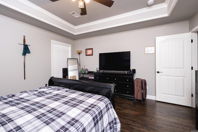 bedroom with baseboards, visible vents, a ceiling fan, a raised ceiling, and dark wood finished floors