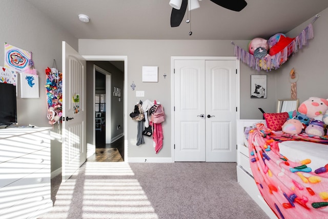 bedroom with ceiling fan, a closet, and carpet